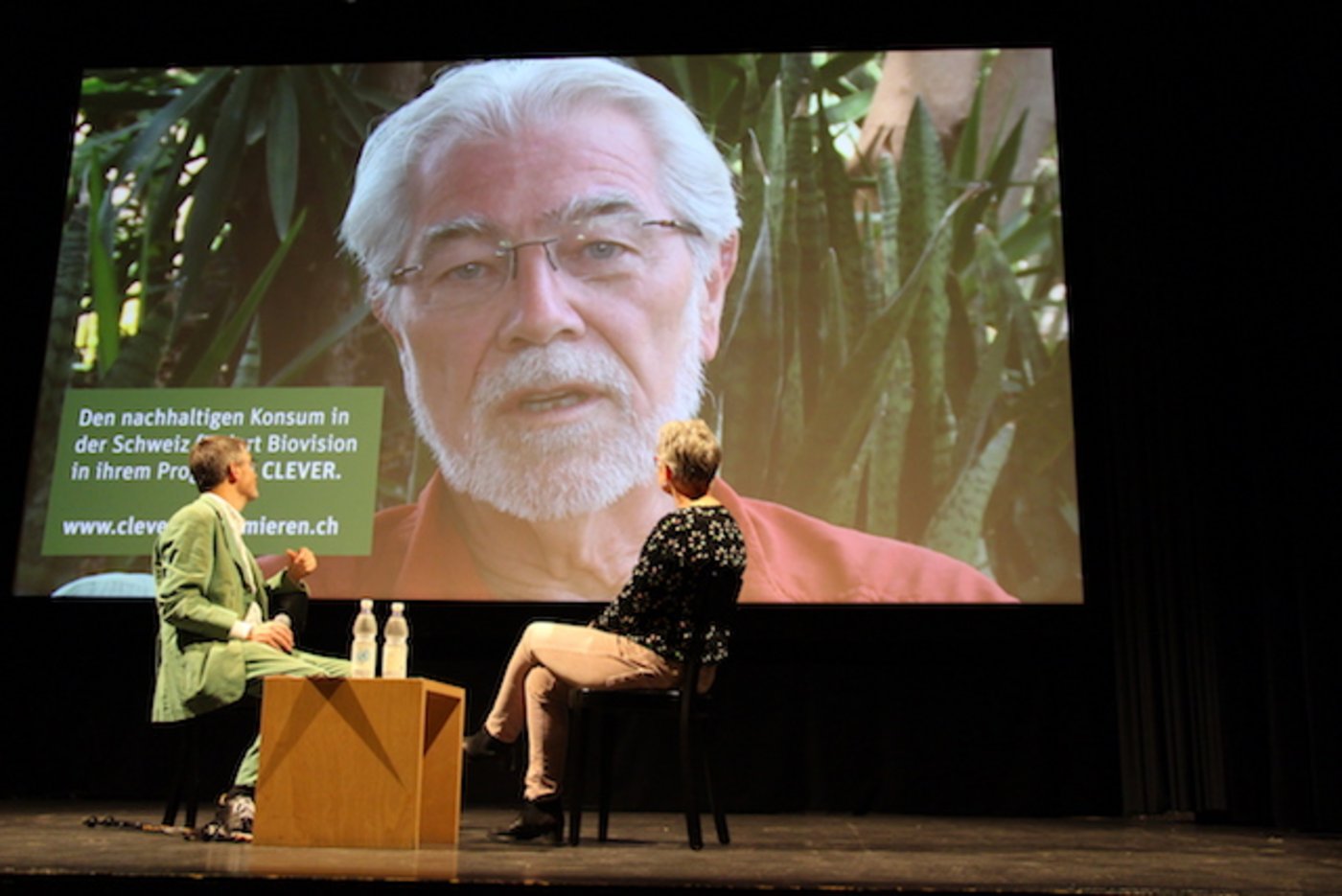 Hans Rudolf Herren, Träger des Welternährungspreises, sprach vom Ufer des Viktoriasee aus in einer Videobotschaft zu den Zuschauern im Kino Odeon in Brugg. Links Thomas Gröbly vom Ethiklabor, rechts Angelika Hilbeck, Agrarökologin. (Bild Hans Rüssli)