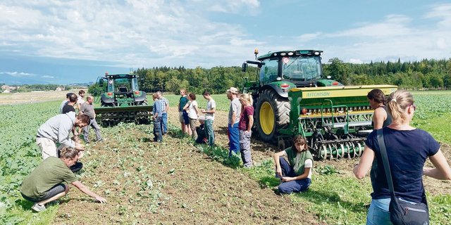 An einem Feldtag von Regenerativ Schweiz in Suchy VD wird den Teilnehmenden erklärt, welche Vorbereitung es für eine optimale Flächenrotte braucht. 