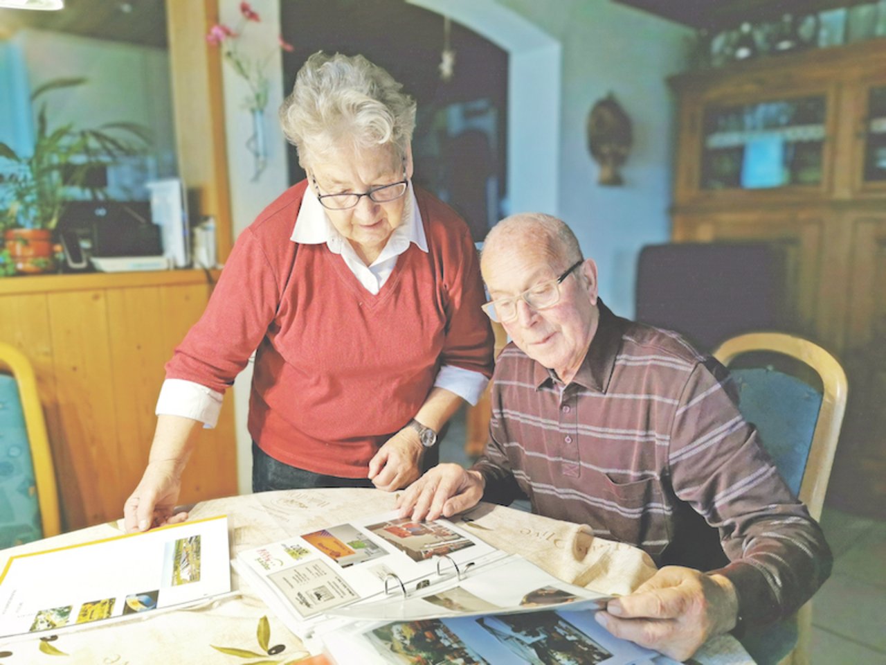 Christine und Peter Burkhalter blättern in einem Fotobuch. Die beiden hatten lange Zeit kein Handy und haben es dennoch geschafft, zusammen ein erfolgreiches kleines Unternehmen auf die Beine zu stellen. Sie zäunten die halbe Westschweiz ein. (Bilder sb)