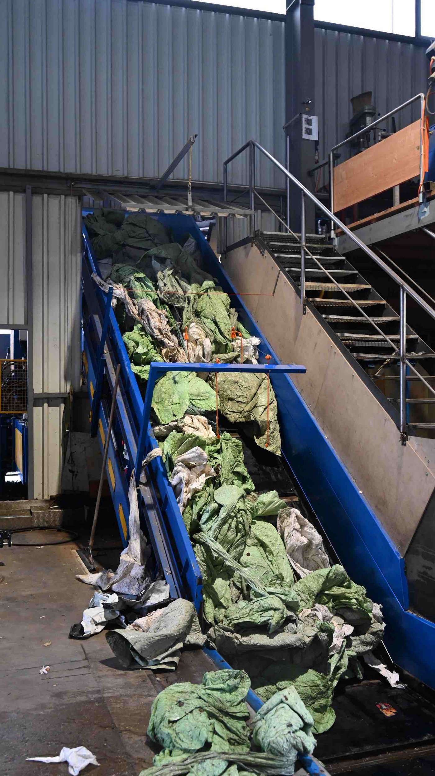 Ein Förderband transportiert die Folien eine Presse. 