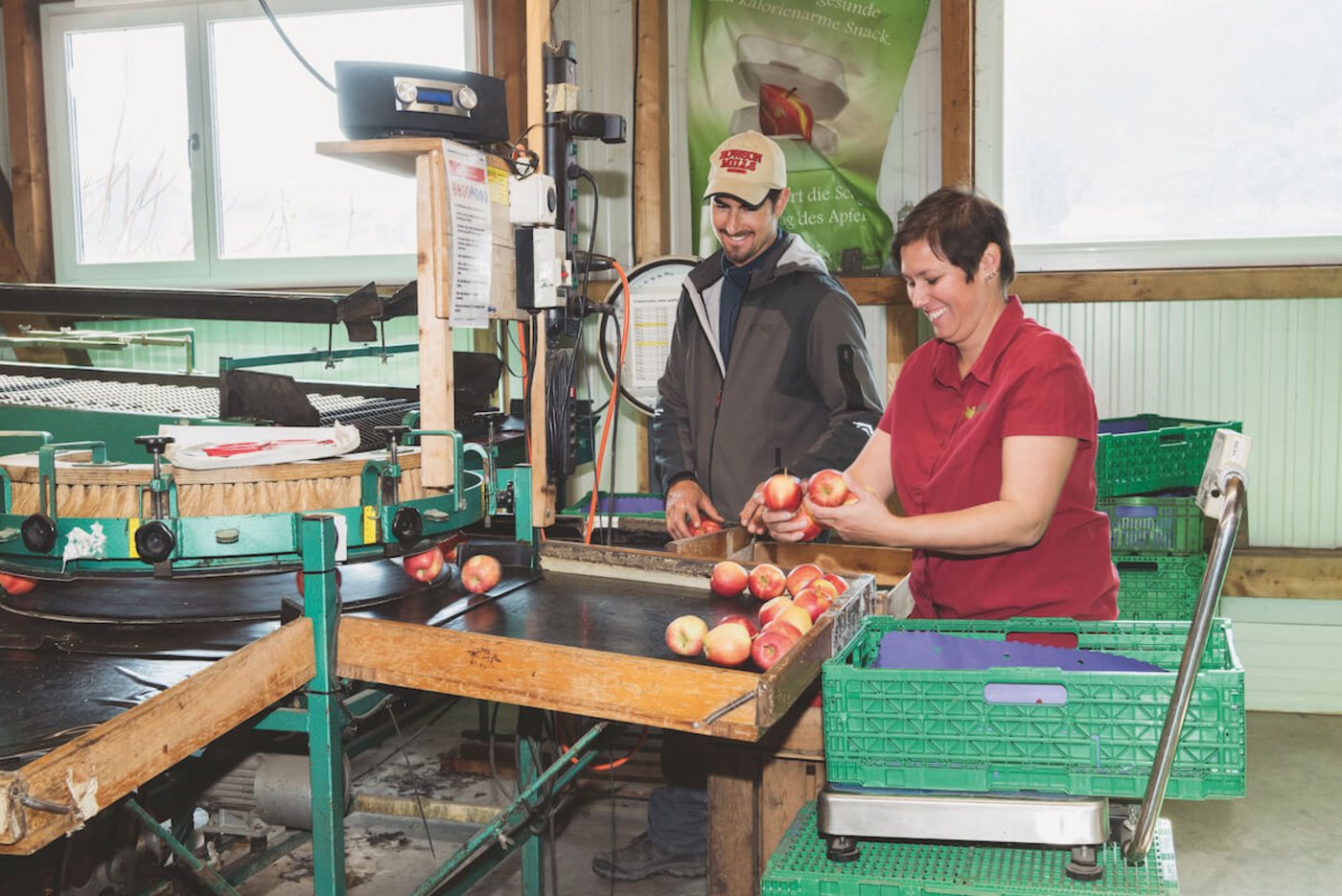 Christoph und Amina Lamprecht an der Sortiermaschine auf dem Obstbaubetrieb. Der hausgemachte Süssmost ist ein Verkaufsschlager. (Foto: Miriam Kolmann)