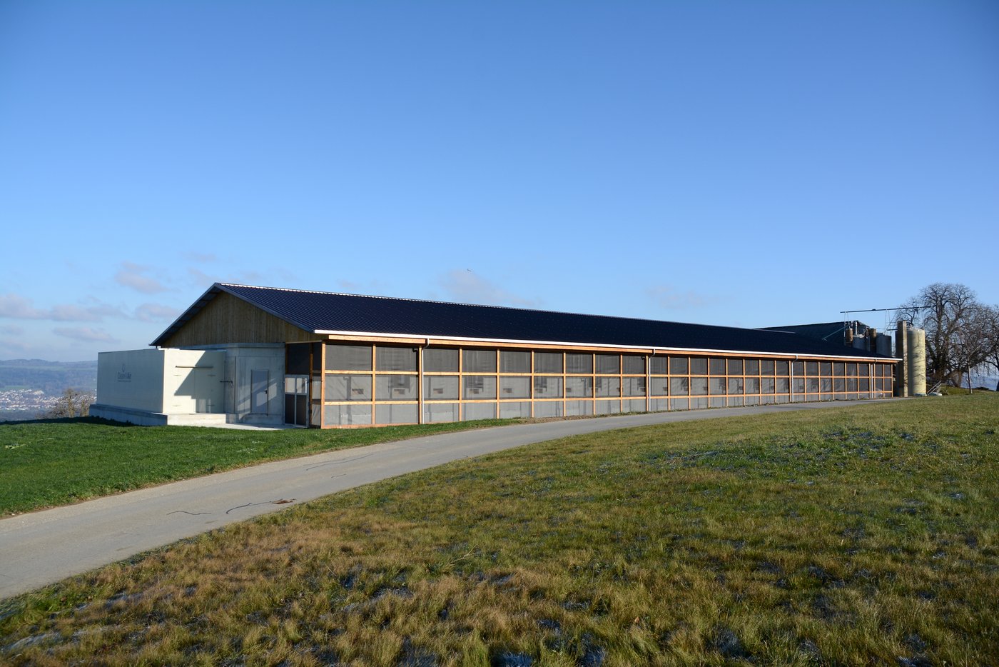 Die neue 21 mal 60 Meter grosse Halle mit Auslauf vorne und Luftwäscher links.